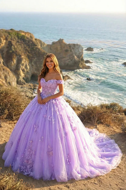 Woman in a lilac ball gown with 3D floral lace, off-shoulder, by the ocean cliffs