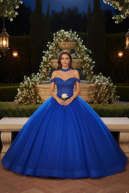 Woman in a royal blue off-the-shoulder ball gown quinceañera dress holding a white rose outdoors.