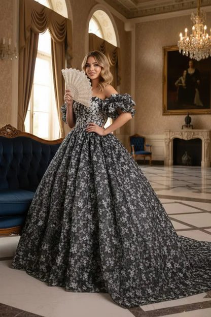 Woman in elegant off-the-shoulder floral ball gown holding lace fan in grand room