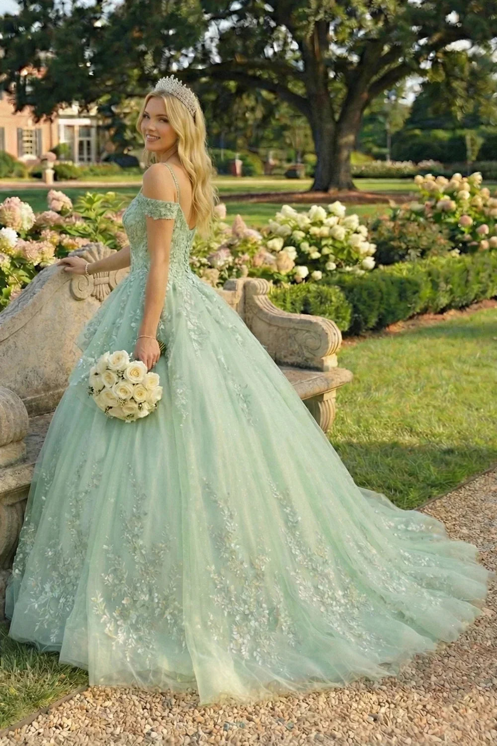 Elegant mint green ball gown with floral embroidery, off-shoulder, tiara, garden setting