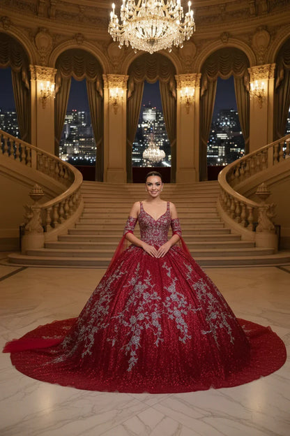 Woman in a red off-the-shoulder embroidered A-line ball gown on a grand staircase
