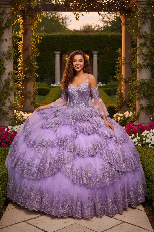 Woman in a lavender layered ruffled ball gown with embroidery posing in a garden