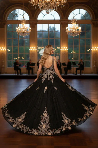 Woman in black ornate floral ball gown with beading, elegant ballroom, chandeliers