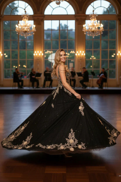 Woman in ornate black floral ball gown with spaghetti straps and beading, ballroom setting