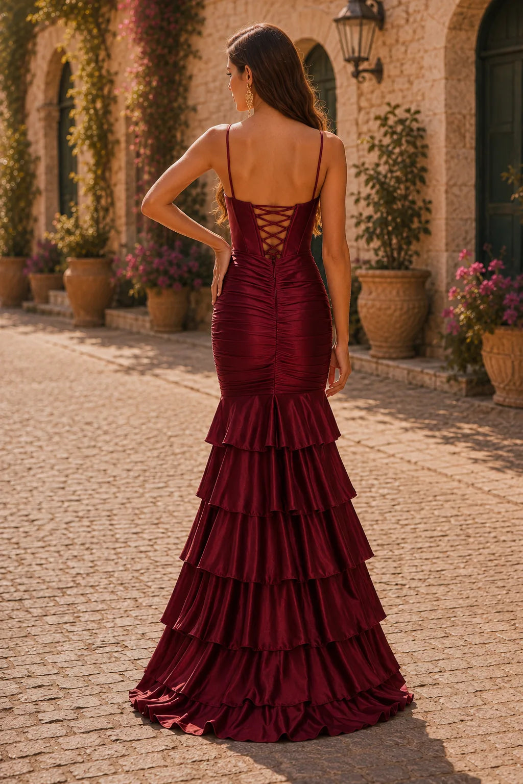 Burgundy spaghetti-strap tiered ruffle prom gown with a slit, back view