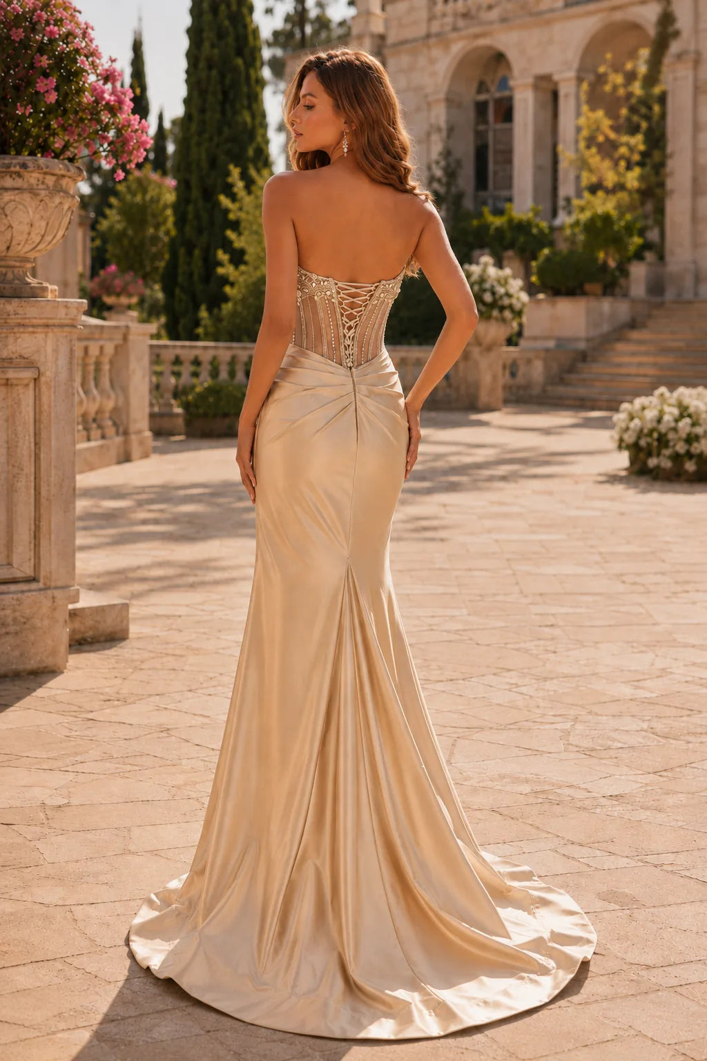 Champagne strapless embellished corset prom gown with a slit, back view